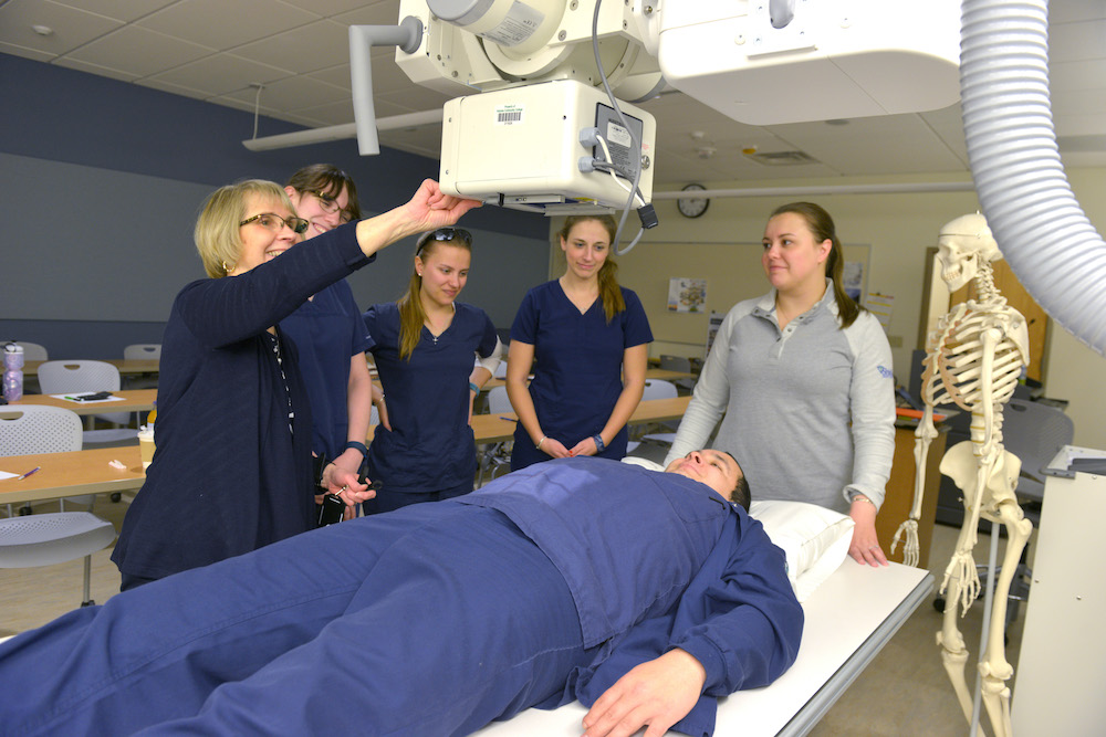 Rad tech students use an X-ray machine